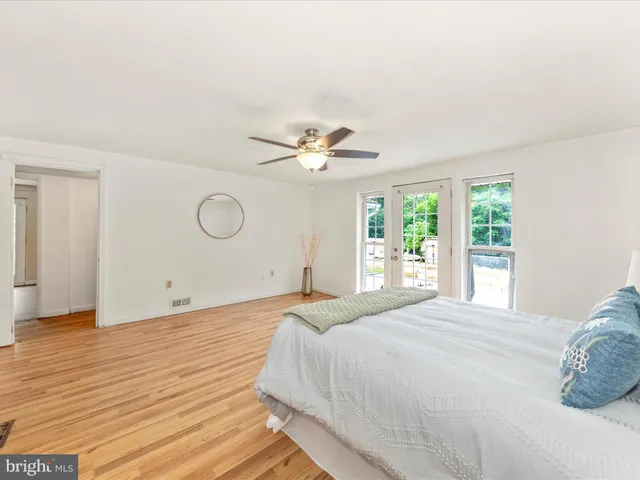 a bedroom with a large bed and a window