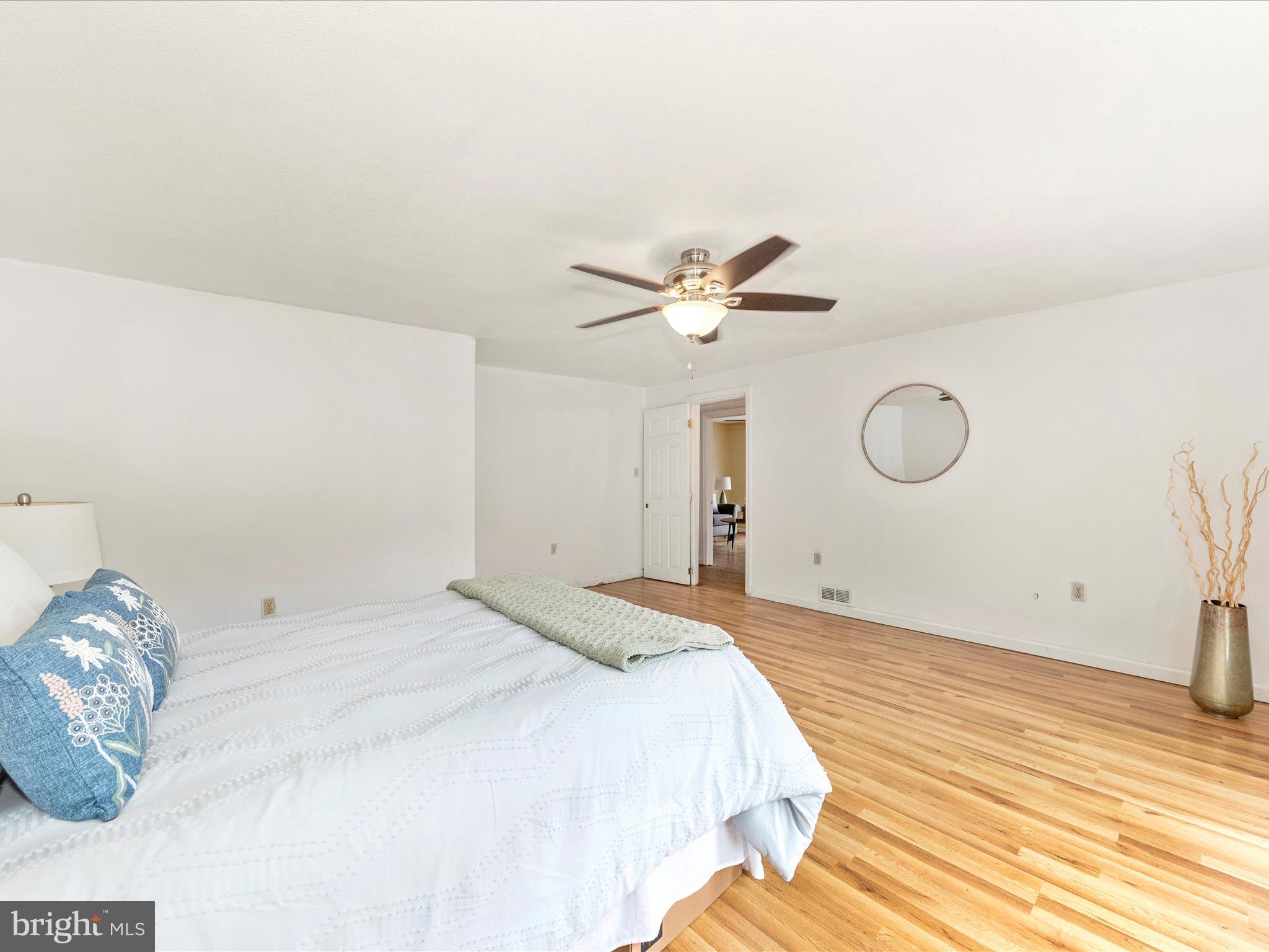 6 Myers Trail Berkeley Springs, WV 25411 - Photo 23 of 39 a bedroom with a large bed and a chandelier