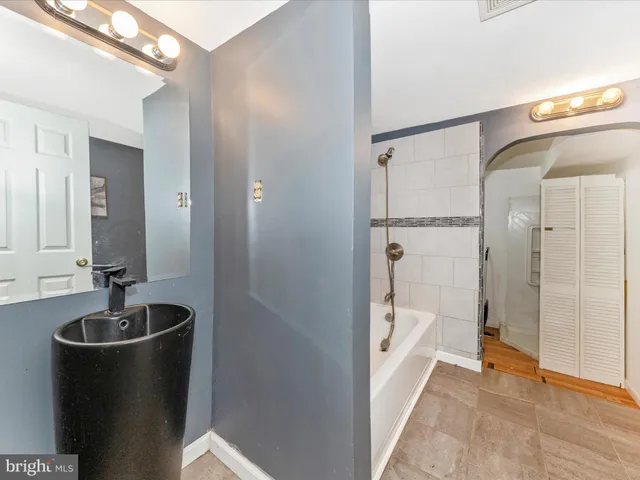 a bathroom with a tub and a shower