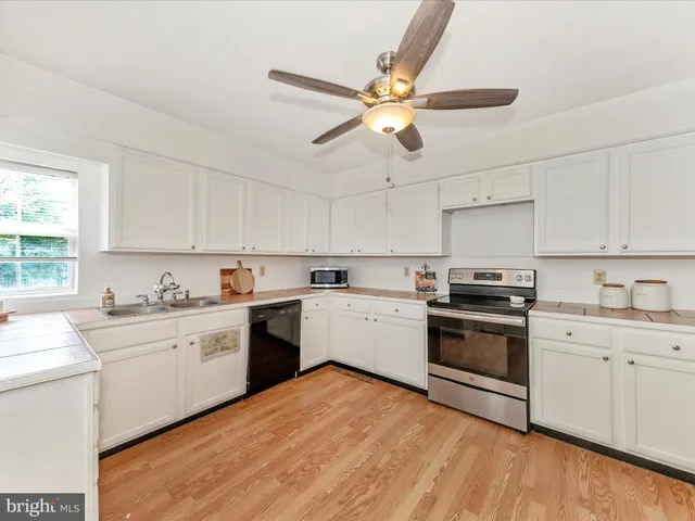 a kitchen with a white cabinets and stainless steel appliances