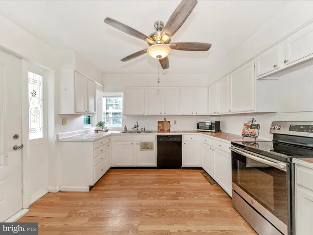 a kitchen with a cabinets stainless steel appliances and a window