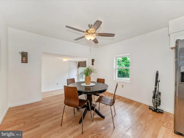 a view of a dining room with furniture and a potted plant