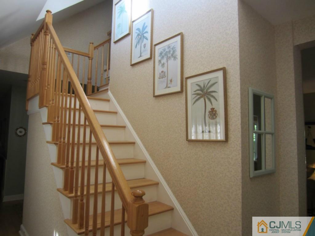 4 Edgebrook Road New Brunswick, NJ 08901 - Photo 11 of 22 a view of staircase with lots of frames on wall and a potted plant