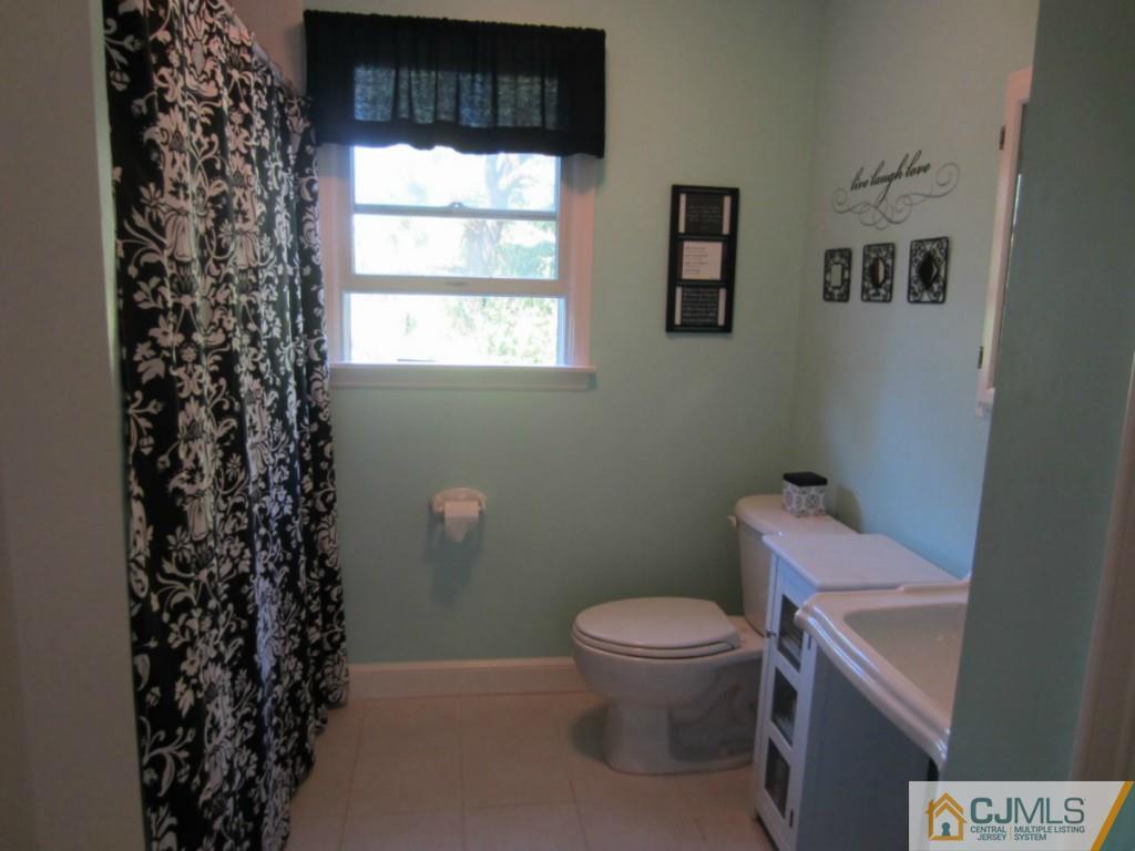 4 Edgebrook Road New Brunswick, NJ 08901 - Photo 19 of 22 a bathroom with a toilet sink and window
