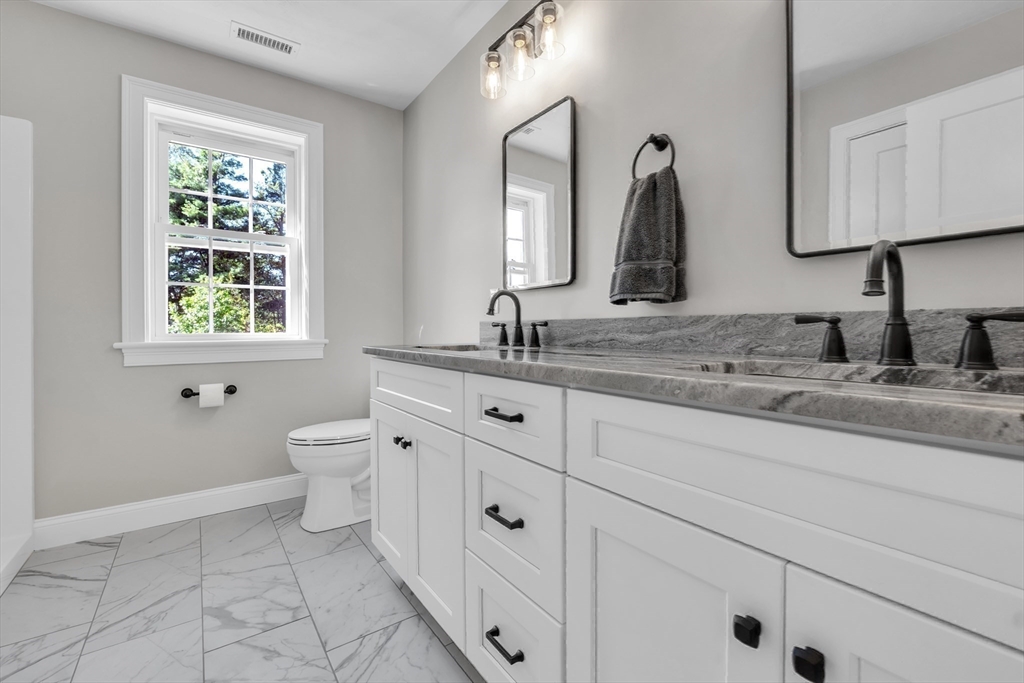 271 Glenwood Road Rutland, MA 01543 - Photo 28 of 36 a bathroom with a granite countertop sink mirror and a toilet