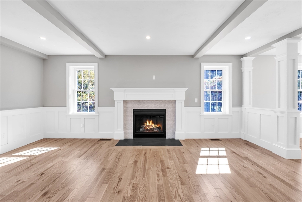 271 Glenwood Road Rutland, MA 01543 - Photo 5 of 36 an empty room with wooden floor fireplace and windows