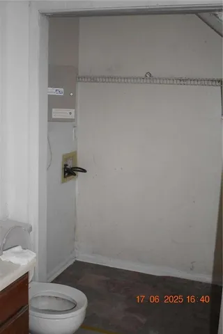 a bathroom with a granite countertop toilet and a shower