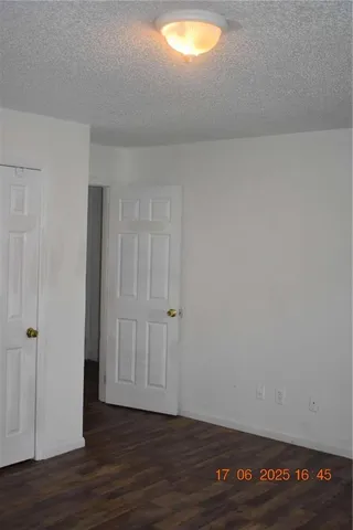 a view of an empty room and wooden floor