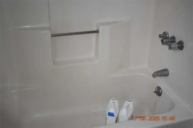 a bath tub sitting next to a shower