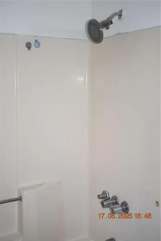 a side view of a house with a yard and potted plants