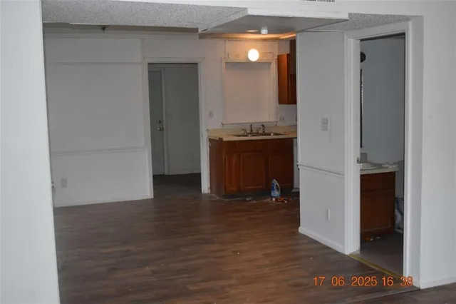 an empty room with wooden floor and cabinet