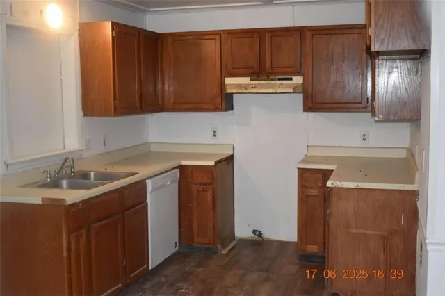 a kitchen with stainless steel appliances granite countertop wooden cabinets a sink and dishwasher