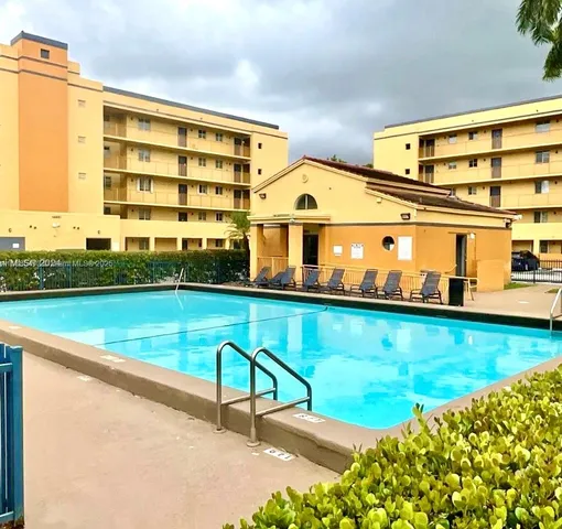 a view of swimming pool with outdoor seating and a yard