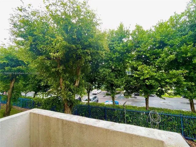 a view of a street with a trees park