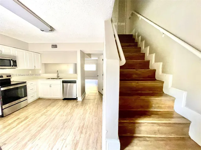 a view of kitchen and wooden floor