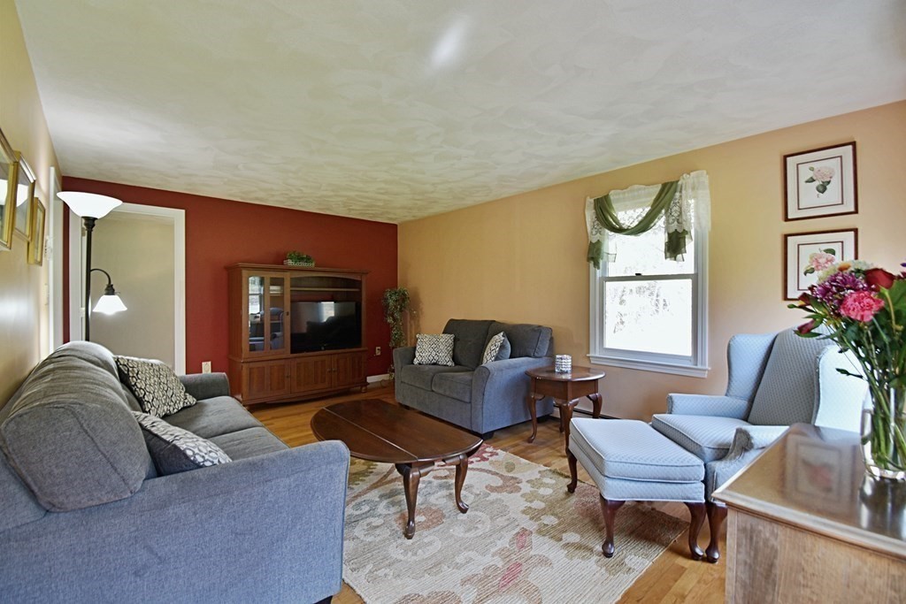 9 Chard Road Tyngsborough, MA 01879 - Photo 12 of 38 a living room with furniture and a fireplace