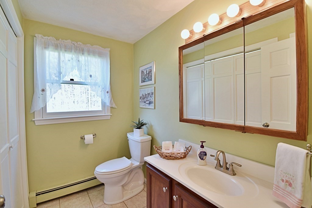 9 Chard Road Tyngsborough, MA 01879 - Photo 14 of 38 a bathroom with a sink vanity mirror and toilet