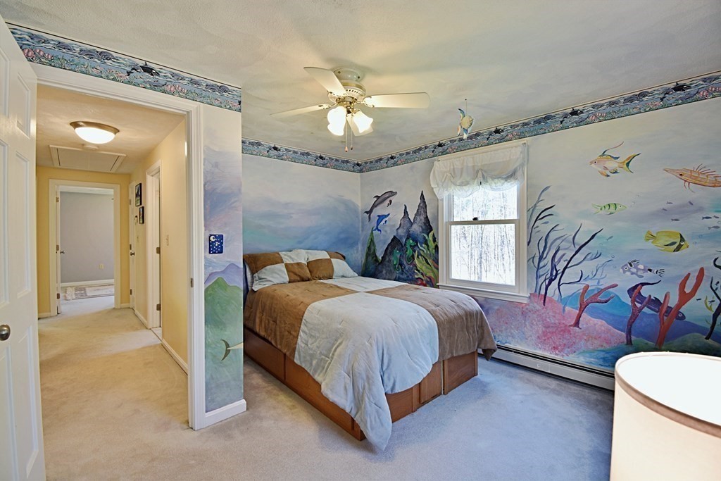 9 Chard Road Tyngsborough, MA 01879 - Photo 23 of 38 a bedroom with a bed and a chandelier
