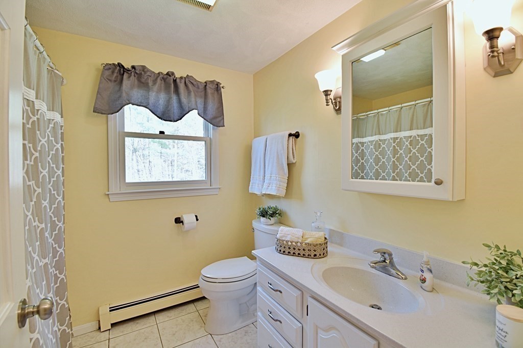 9 Chard Road Tyngsborough, MA 01879 - Photo 26 of 38 a bathroom with a toilet sink and mirror