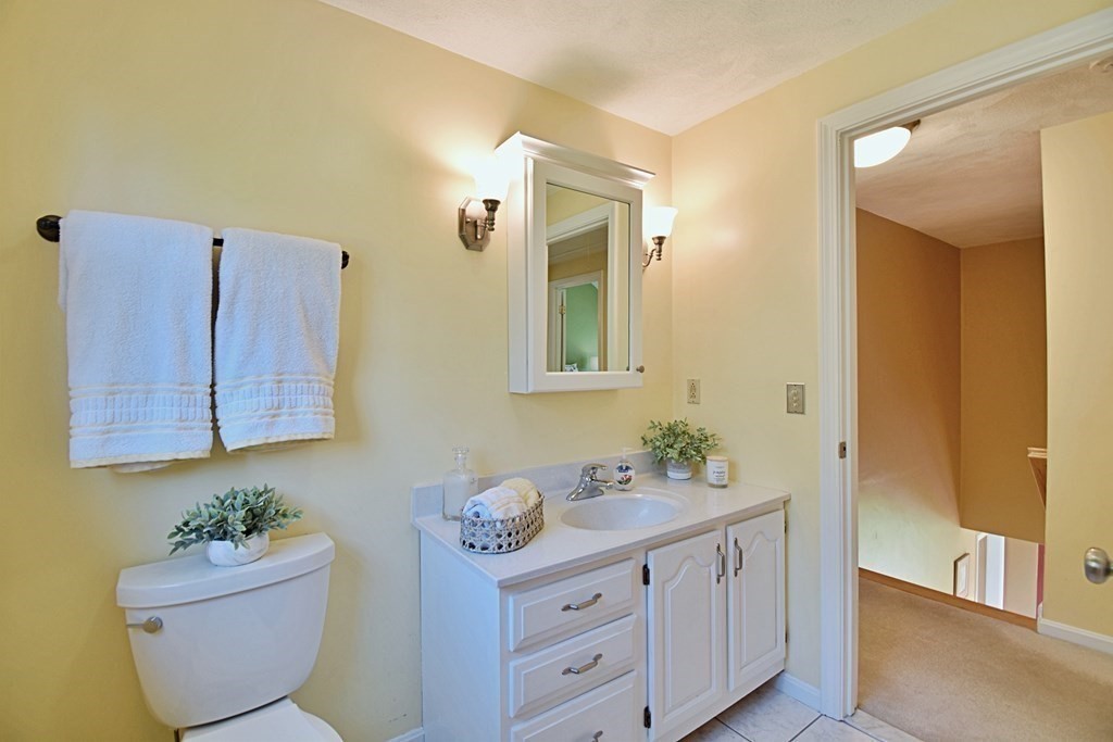 9 Chard Road Tyngsborough, MA 01879 - Photo 27 of 38 a bathroom with a toilet sink and mirror