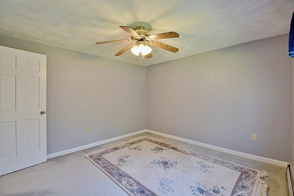 9 Chard Road Tyngsborough, MA 01879 - Photo 31 of 38 an empty room with a window and chandelier fan
