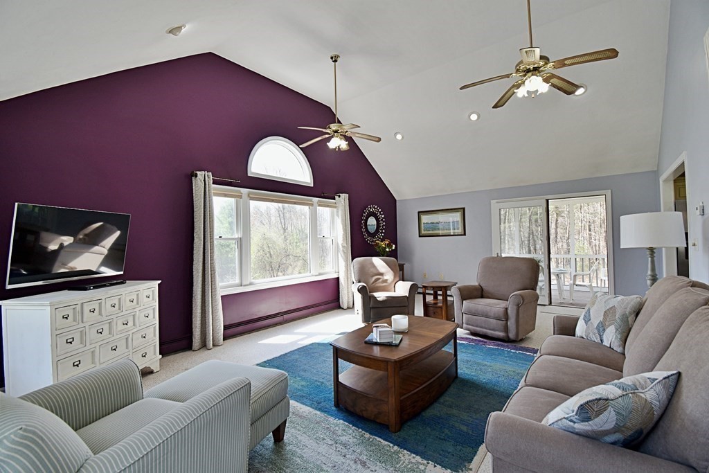 9 Chard Road Tyngsborough, MA 01879 - Photo 7 of 38 a living room with furniture a large window and a flat screen tv