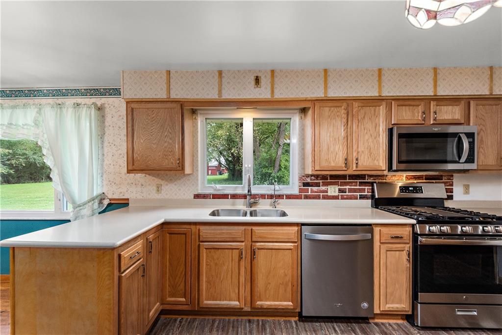 110 Forresta Drive Butler, PA 16002 - Photo 11 of 25 a kitchen with stainless steel appliances a sink stove and microwave