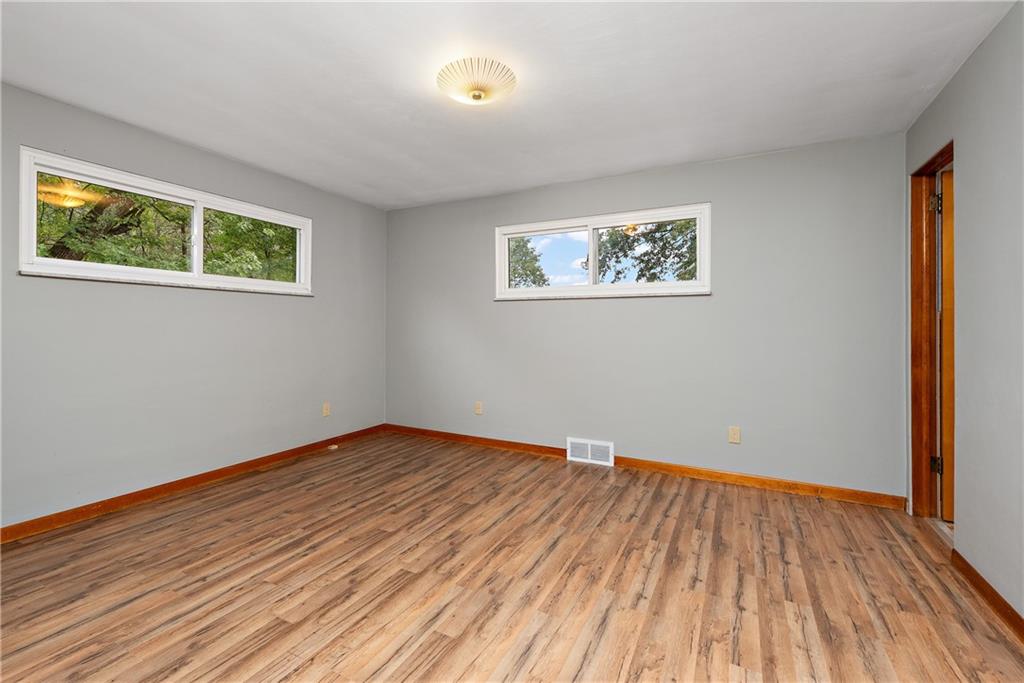 110 Forresta Drive Butler, PA 16002 - Photo 14 of 25 a view of an empty room with wooden floor and a window