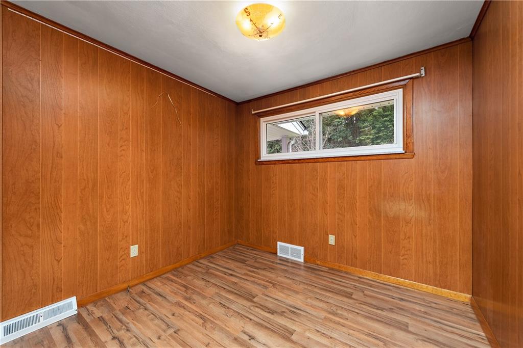 110 Forresta Drive Butler, PA 16002 - Photo 17 of 25 a view of an empty room with wooden floor and a window