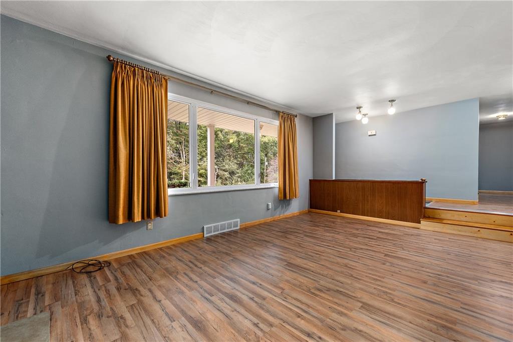 110 Forresta Drive Butler, PA 16002 - Photo 4 of 25 a view of an empty room with wooden floor and a window
