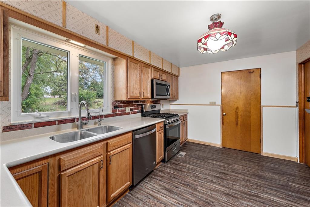 110 Forresta Drive Butler, PA 16002 - Photo 7 of 25 a kitchen with a sink appliances cabinets and a large window