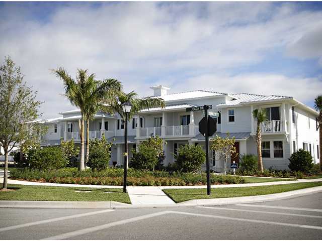 1011 Key Largo Street Jupiter, FL 33458 - Photo 5 of 6 a view of a building with a yard and large trees
