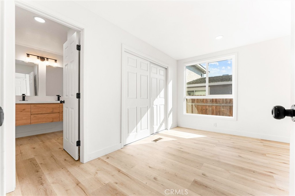 10872 Flower Avenue Stanton, CA 90680 - Photo 10 of 26 a view of an empty room with wooden floor and a window