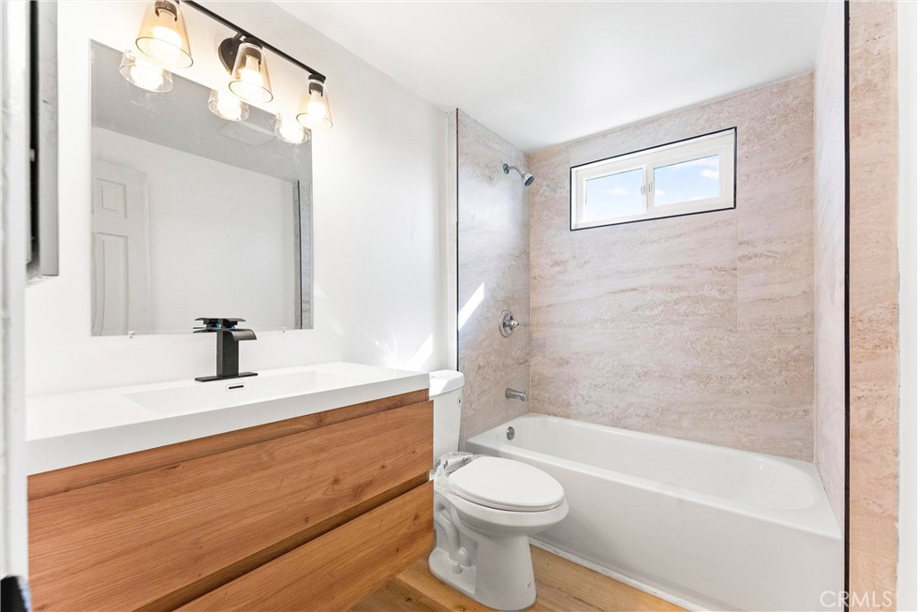 10872 Flower Avenue Stanton, CA 90680 - Photo 13 of 26 a bathroom with a sink a toilet and a bathtub