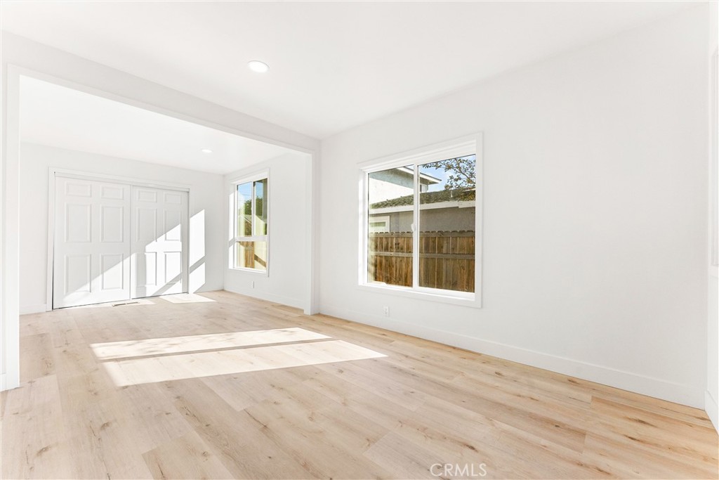 10872 Flower Avenue Stanton, CA 90680 - Photo 13 of 26 an empty room with wooden floor and windows