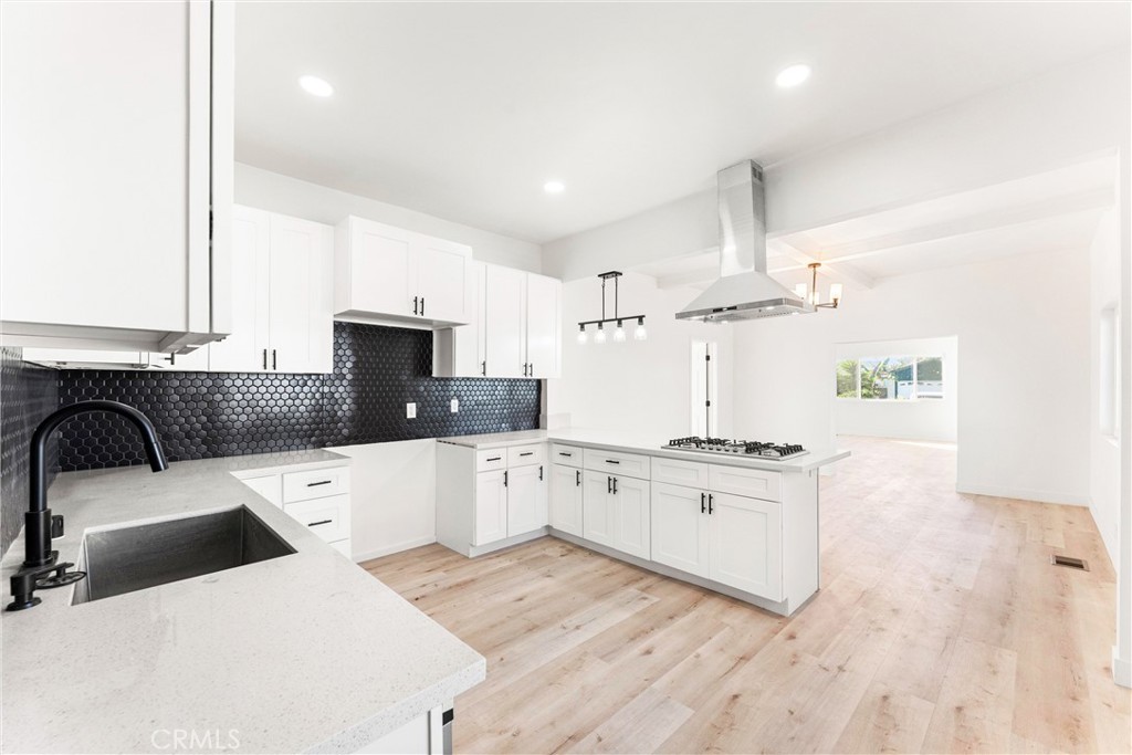 10872 Flower Avenue Stanton, CA 90680 - Photo 1 of 26 a kitchen with stainless steel appliances white cabinets a sink a stove a refrigerator and a stove