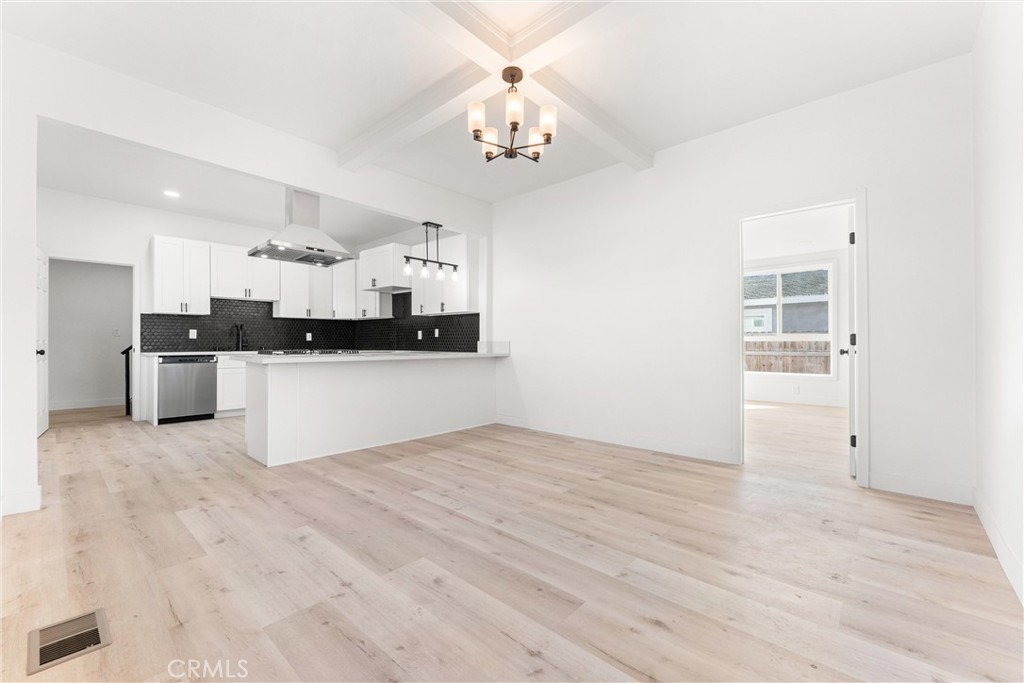 10872 Flower Avenue Stanton, CA 90680 - Photo 3 of 26 a large kitchen with granite countertop a stove top oven a sink a counter space and cabinets