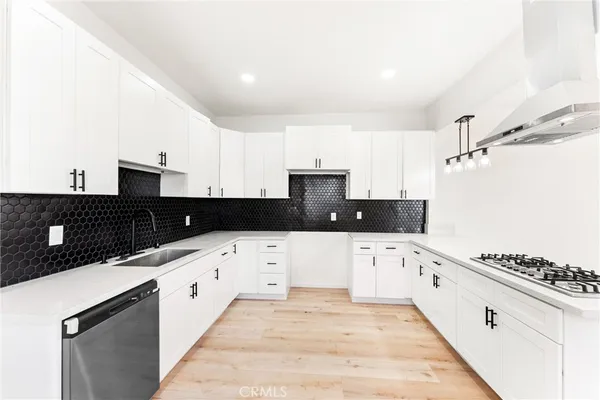 a kitchen with granite countertop a sink and white appliances