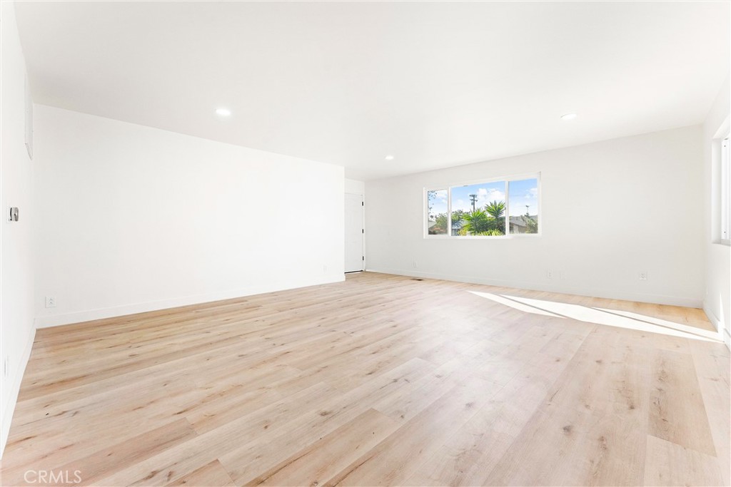 10872 Flower Avenue Stanton, CA 90680 - Photo 9 of 26 an empty room with wooden floor and window