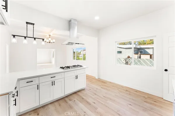 a room with white cabinets and window