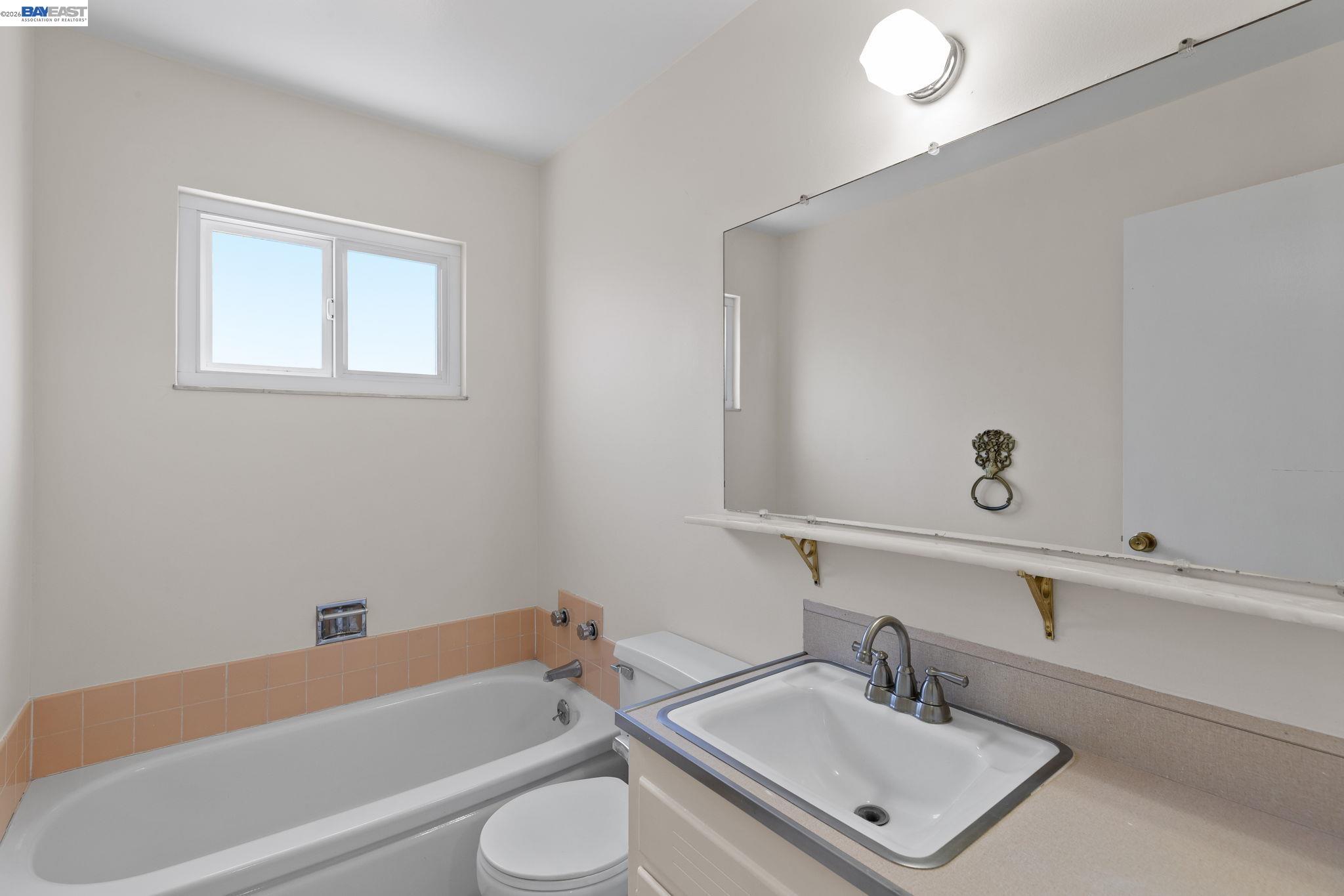 40272 Davis Street Fremont, CA 94538 - Photo 25 of 46 a bathroom with a sink a toilet and shower