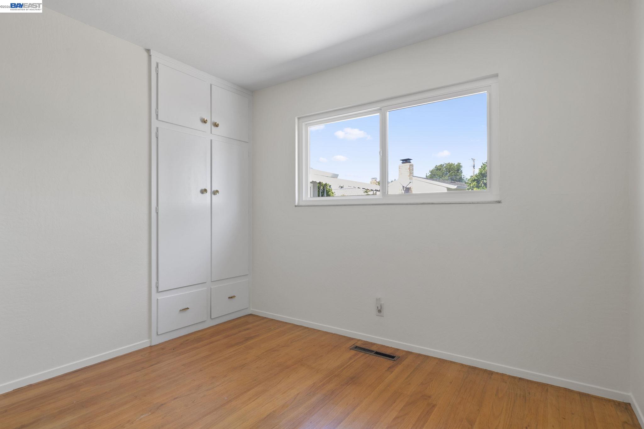 40272 Davis Street Fremont, CA 94538 - Photo 27 of 46 a view of an empty room with wooden floor and a window