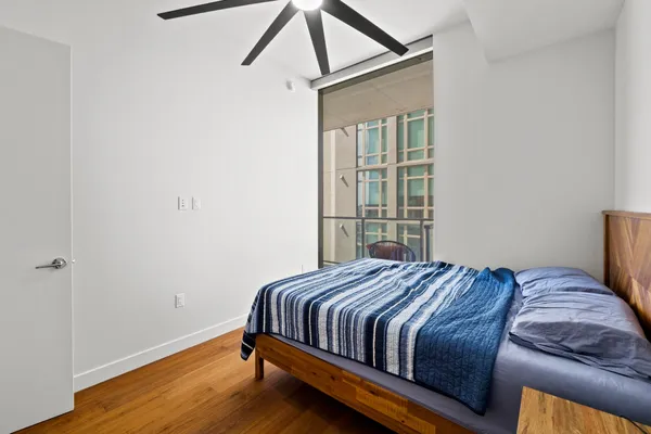 a bedroom with a bed and a window