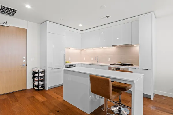 a kitchen with stainless steel appliances granite countertop a stove and a refrigerator
