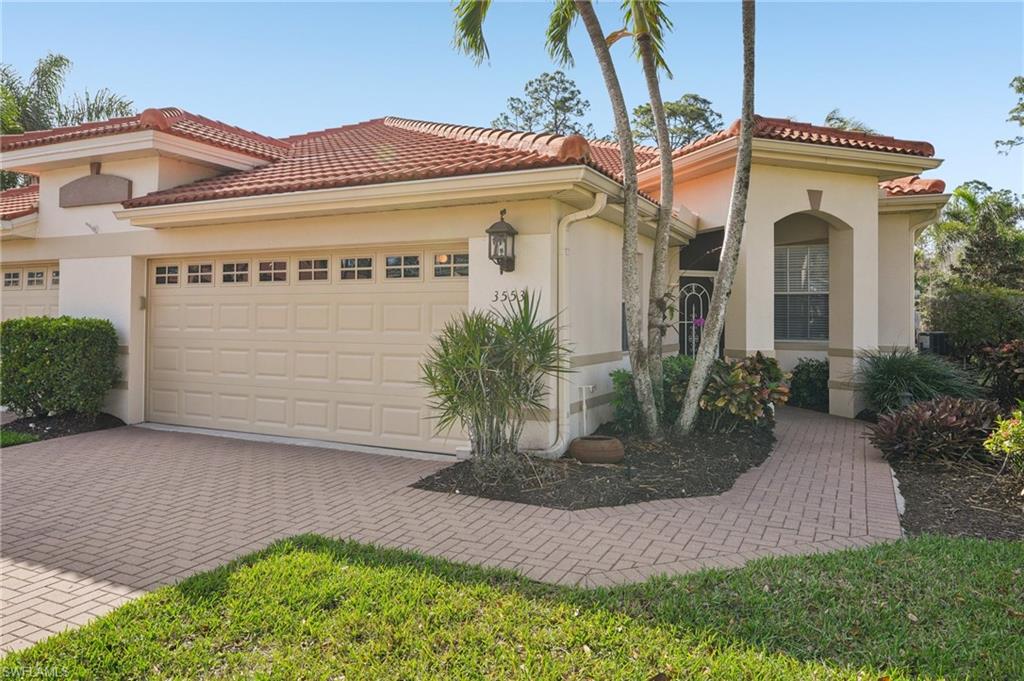 3553 Periwinkle Way Naples, FL 34114 - Photo 1 of 43 Mediterranean / spanish home with a tiled roof, stucco siding, decorative driveway, and a garage