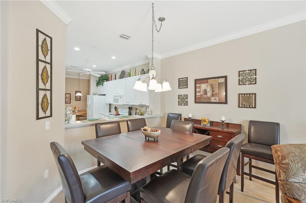 3553 Periwinkle Way Naples, FL 34114 - Photo 11 of 43 Dining space featuring baseboards, ornamental molding, visible vents, recessed lighting, and ceiling fan with notable chandelier