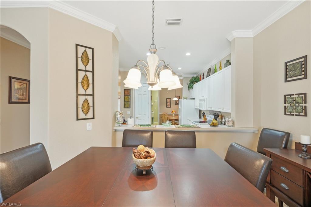 3553 Periwinkle Way Naples, FL 34114 - Photo 12 of 43 Dining area with visible vents, recessed lighting, crown molding, and arched walkways