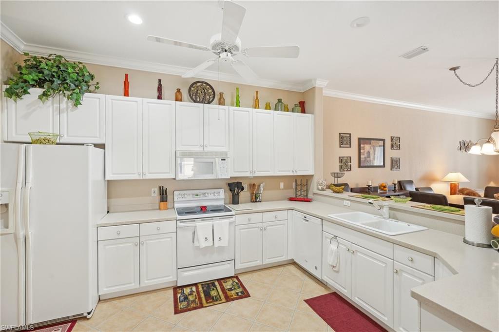 3553 Periwinkle Way Naples, FL 34114 - Photo 17 of 43 Kitchen with light countertops, white cabinets, a sink, and white appliances