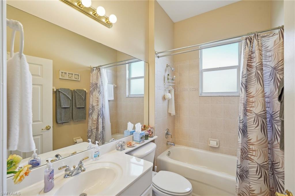 3553 Periwinkle Way Naples, FL 34114 - Photo 21 of 43 Full bath featuring shower / bathtub combination with curtain, a wealth of natural light, toilet, and vanity