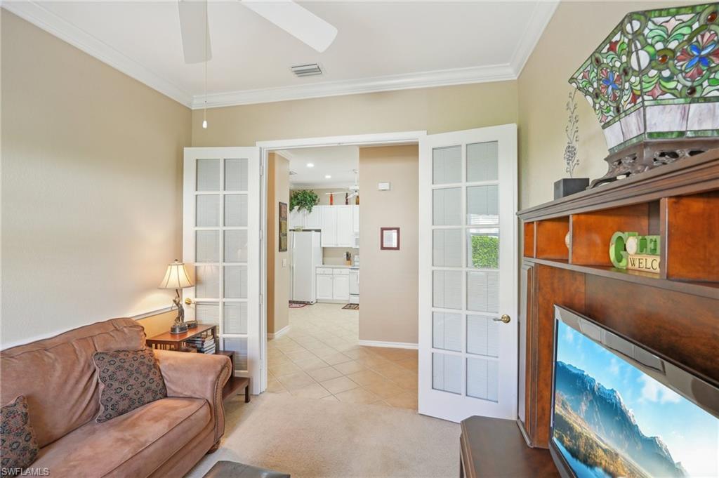 3553 Periwinkle Way Naples, FL 34114 - Photo 23 of 43 Living room featuring a ceiling fan, light tile patterned floors, baseboards, ornamental molding, and visible vents